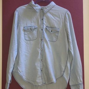 Light-washed blue long-sleeve button down top.